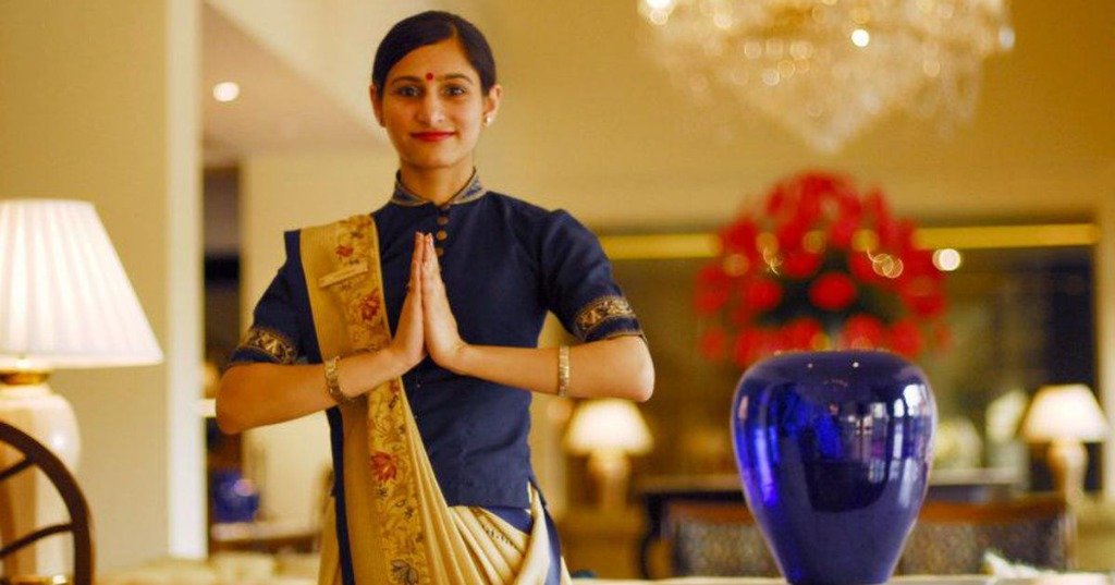Radiance Hospitality staff member welcoming guests with a warm namaste gesture