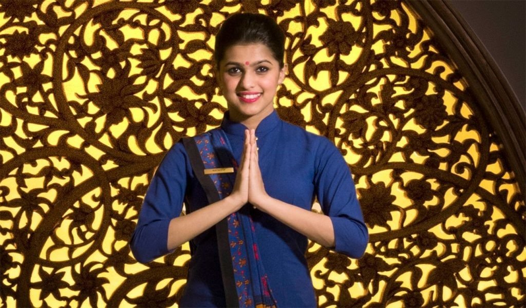 Radiance Hospitality staff member in traditional attire providing personalized guest services